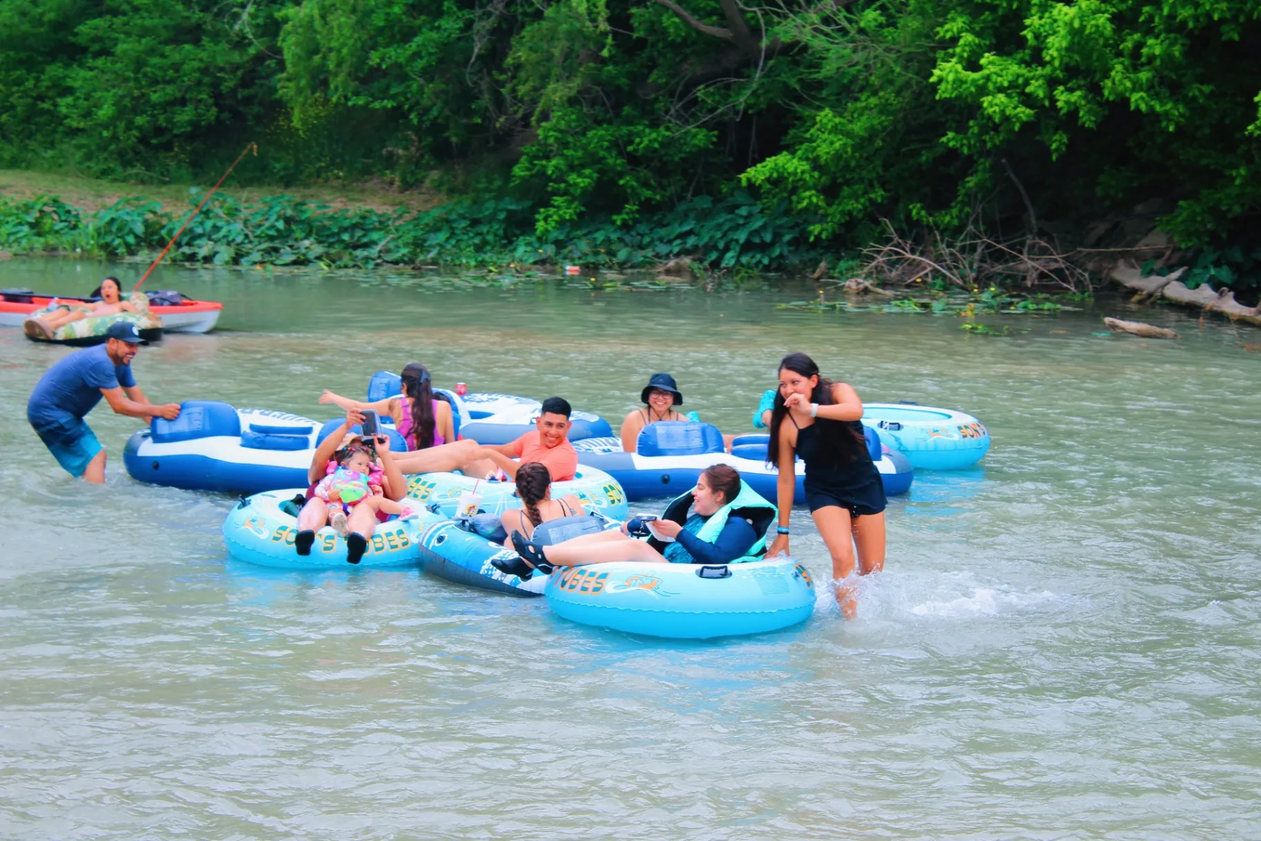 Family kayaking on the San Marcos River at Son's River Ranch