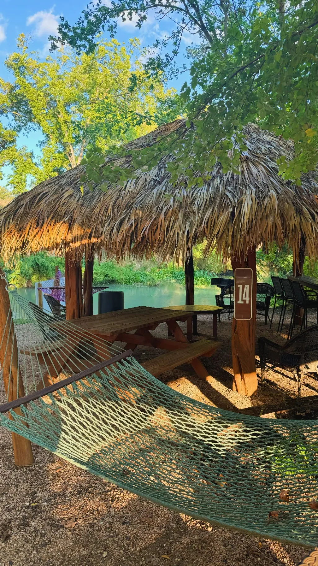 Riverside cabana with shade and river views at Son's River Ranch