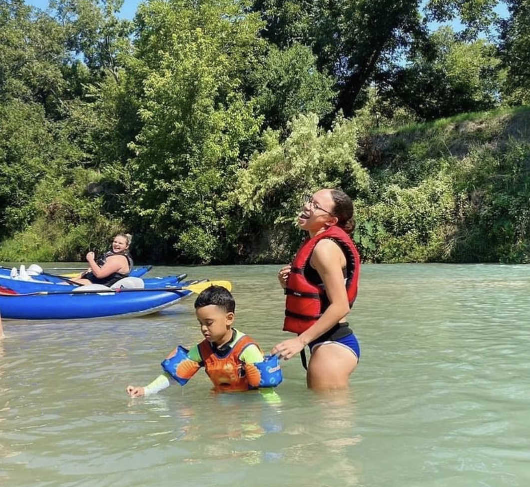 Family swimming with life vests