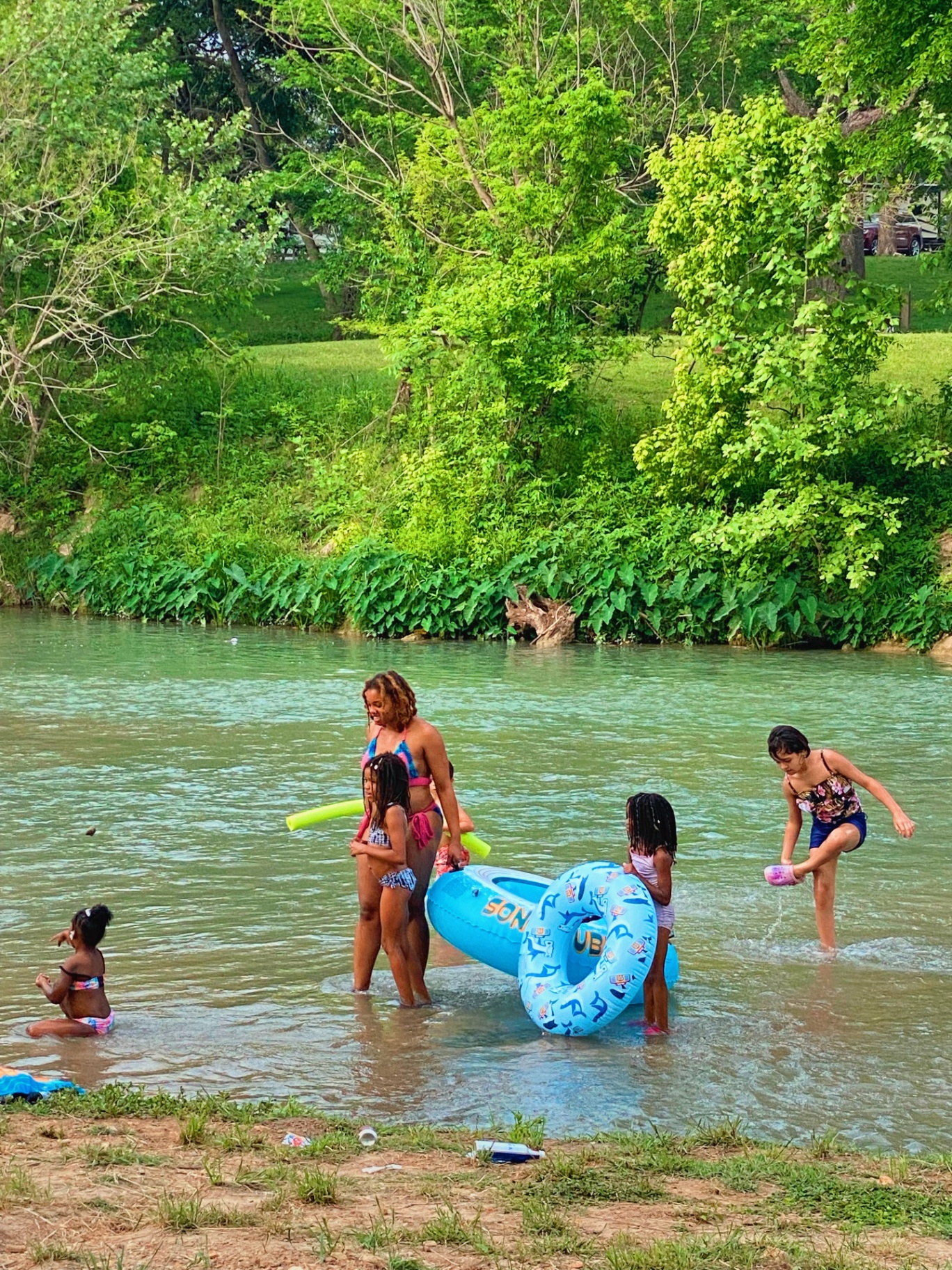 Kids playing in the river with tubes