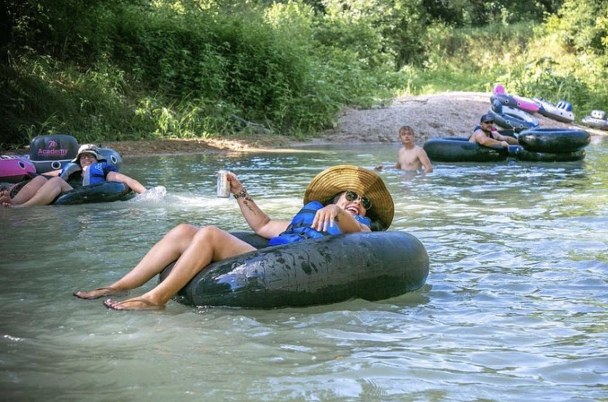 Woman tubing with straw hat