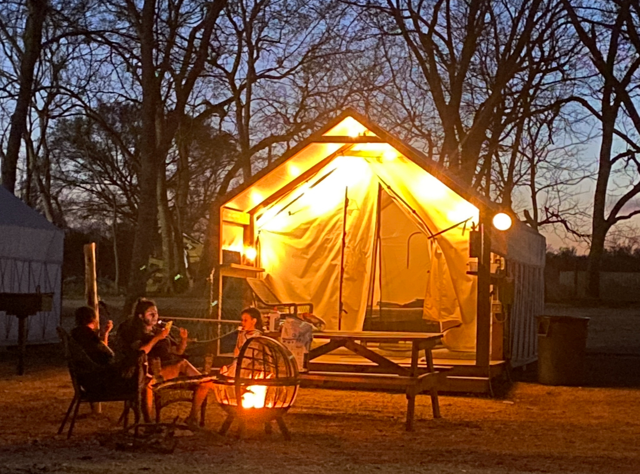 Family by fire pit at Glamping Cabin