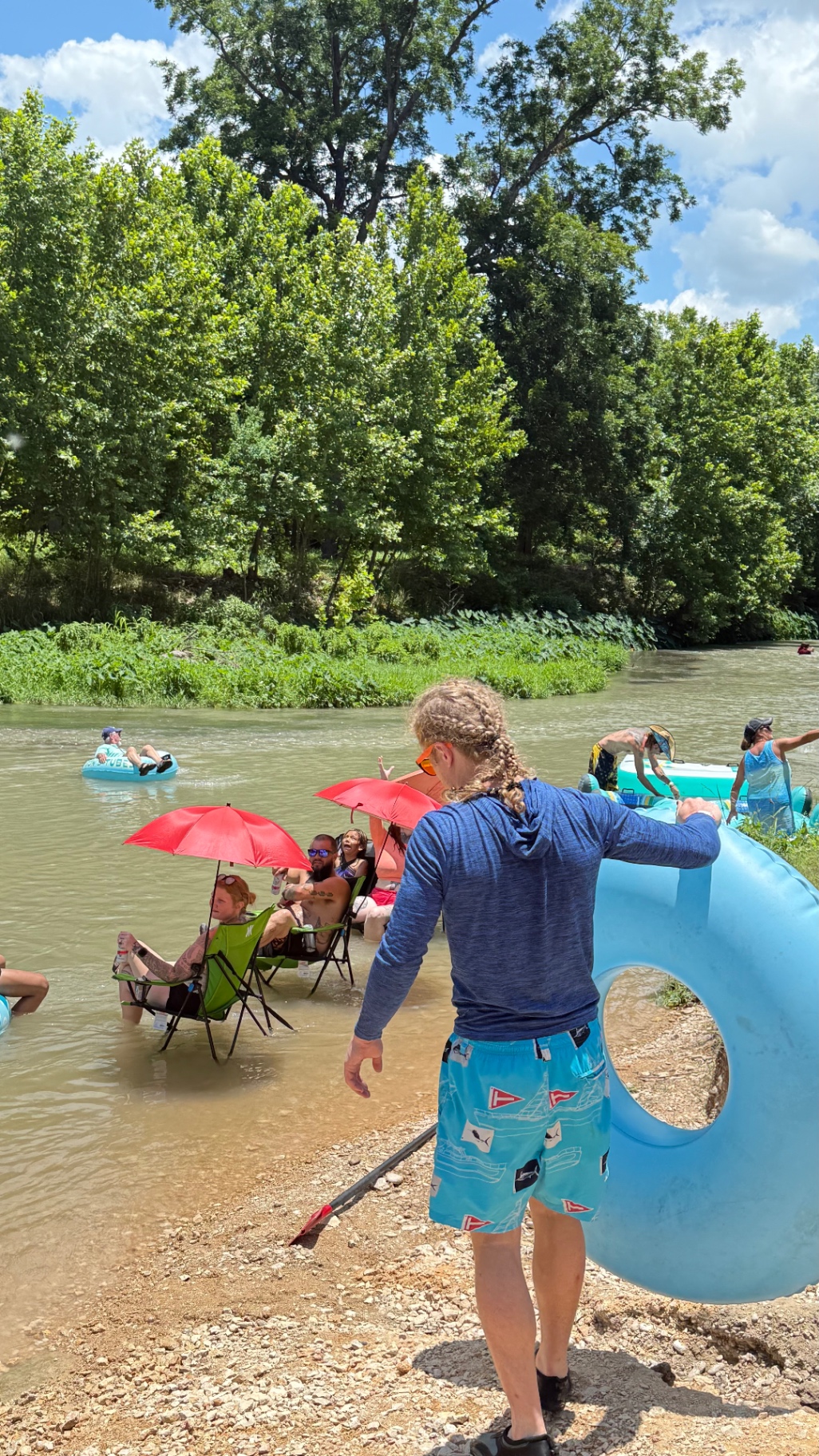 Guests enjoying the river with tubes and chairs