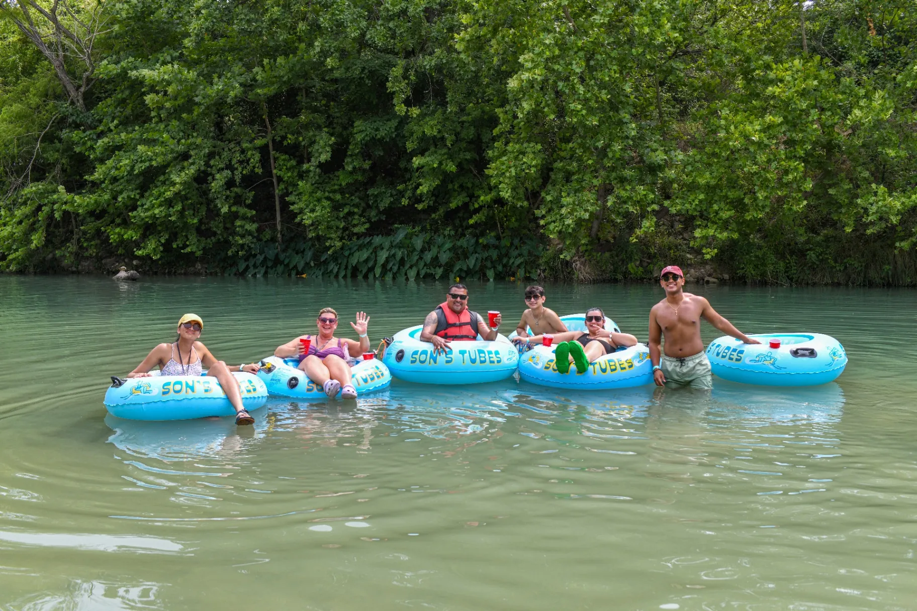 Friends tubing together on the river