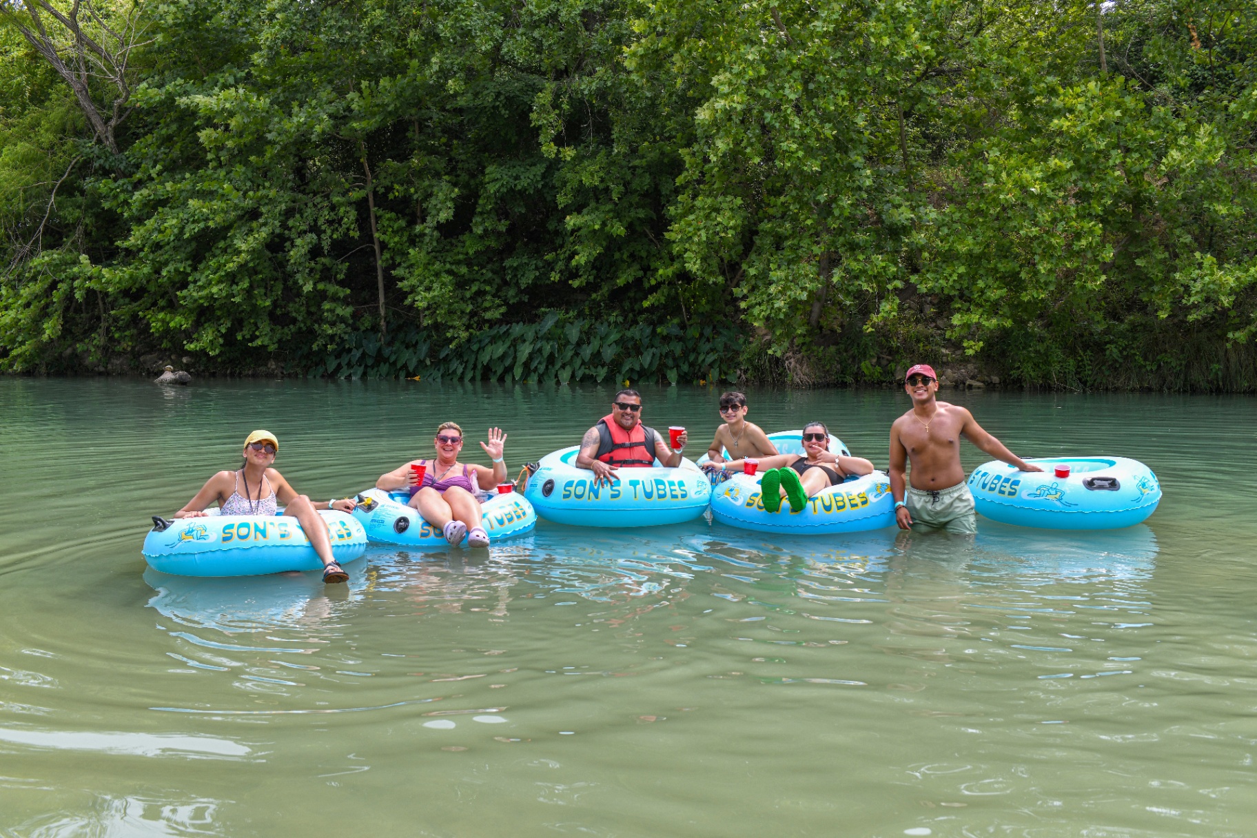 Friends enjoying tubing on the San Marcos River at Son's River Ranch